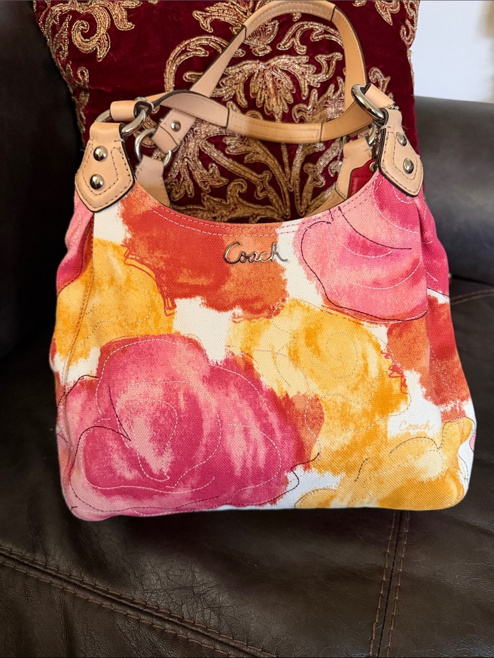 2013 Coach Ashley hobo handbag featuring a vibrant pink, orange, and yellow. EUC